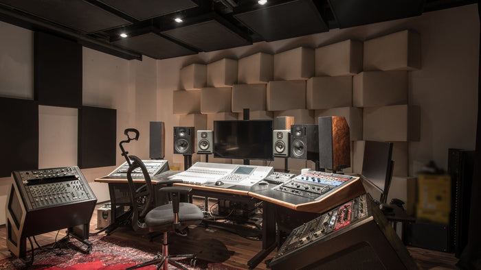 loudspeakers sitting on the stands in a studio